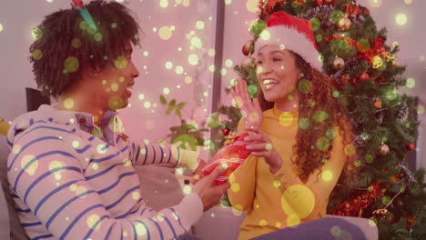 celebrating christmas, couple exchanging gifts over festive lights animation