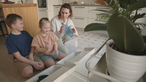 family recycling and organizing in the kitchen