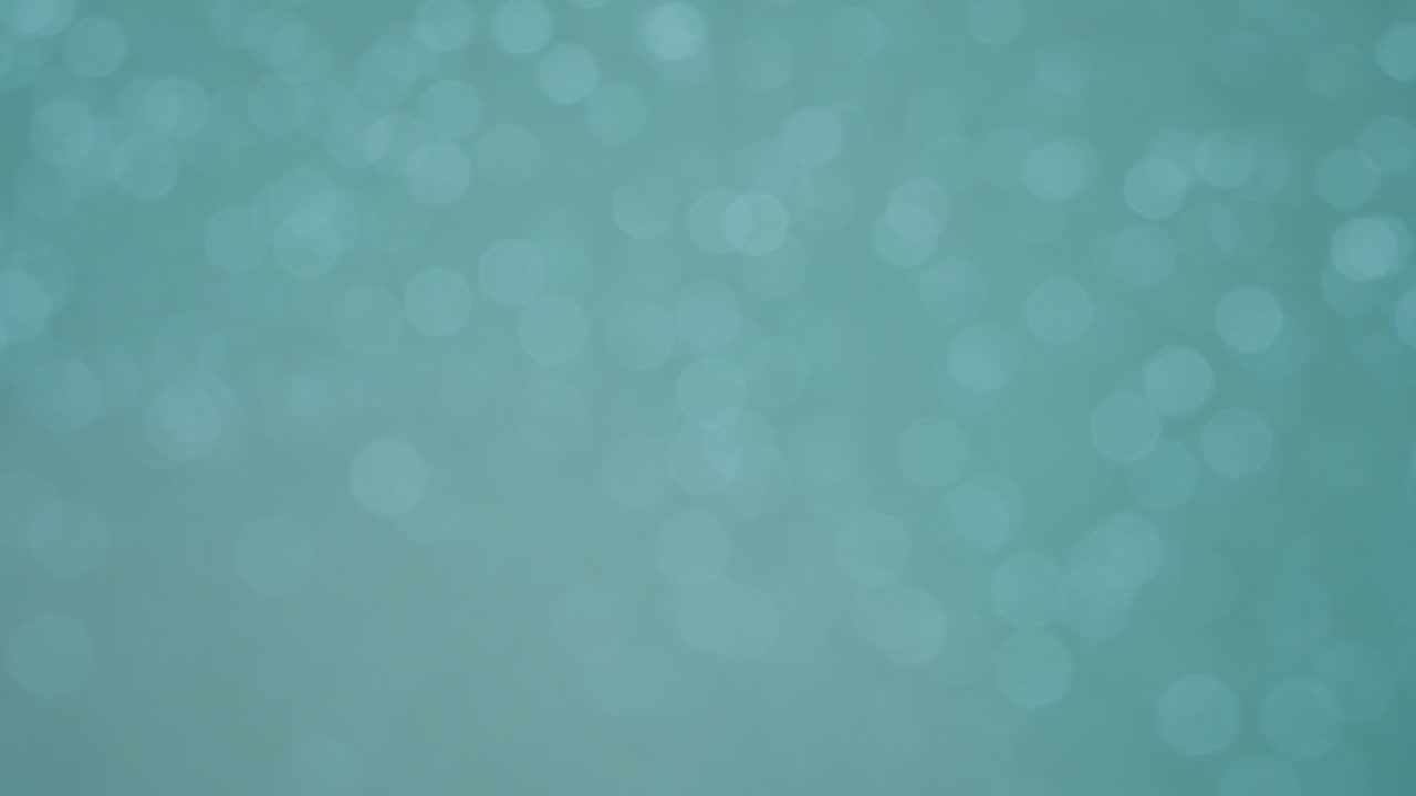 Subtil roterende blinkende cyan bokeh karrusel