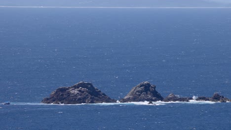 a serene view of waves hitting rocky outcrops