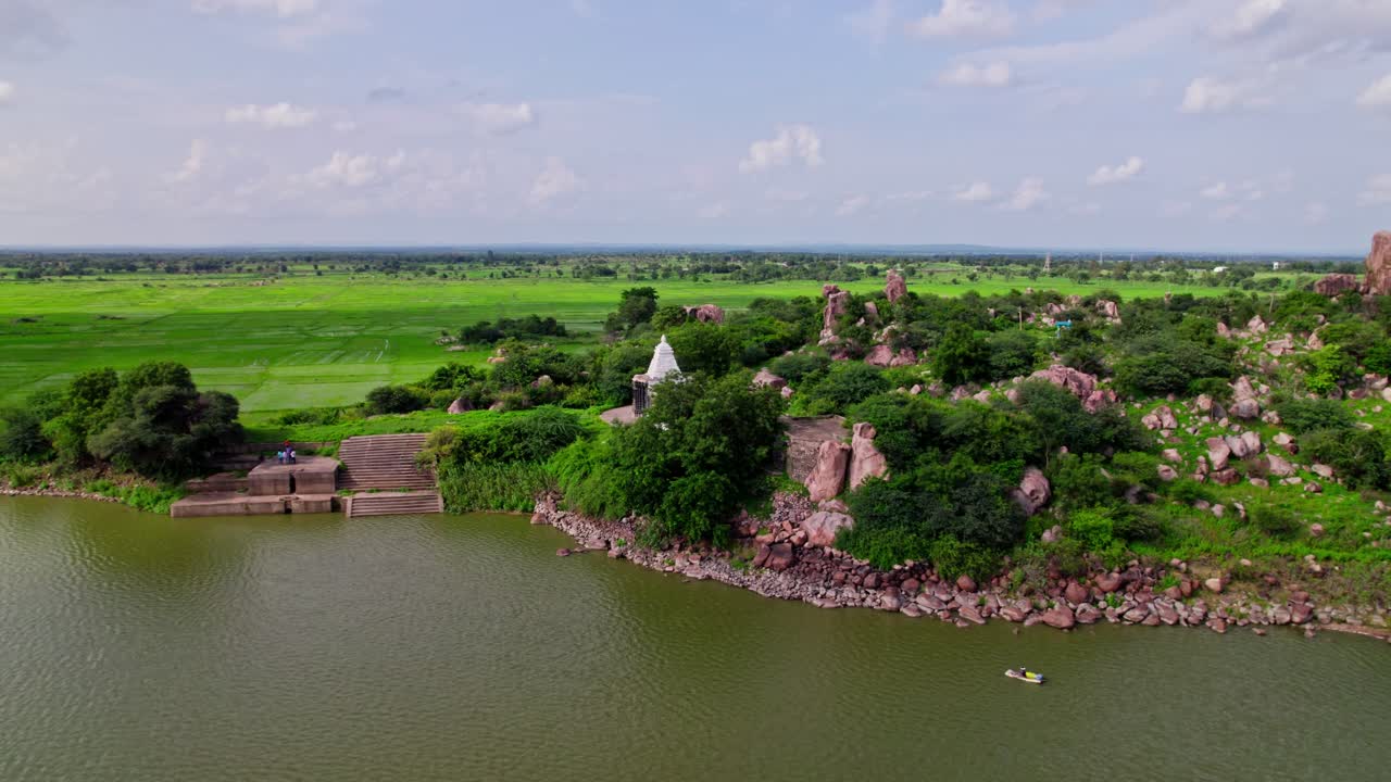 greenery, lake, with crop fields lands, granite hill and Thumbureshwara temple at yelupu Gonda, Surampally, tekmal, Telangana, india. day time, push back, drone shot, 4k.