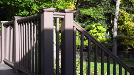 still take of a plastic fence on a deck, the high sun shining through on a warm day