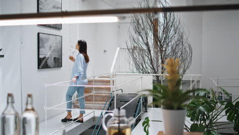 woman resting modern kitchen in modern interior. thoughtful girl drinking tea