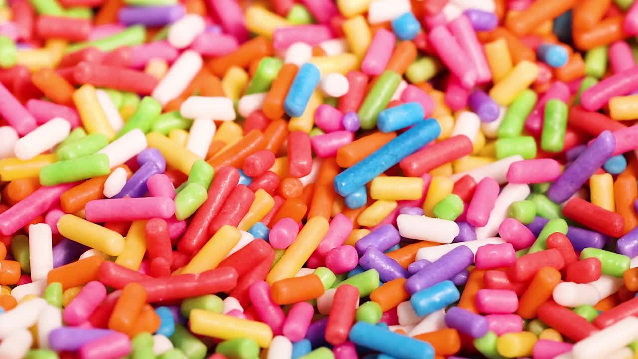 A vibrant close-up view of multicolored sugar sprinkles, showcasing their bright and cheerful appearance.