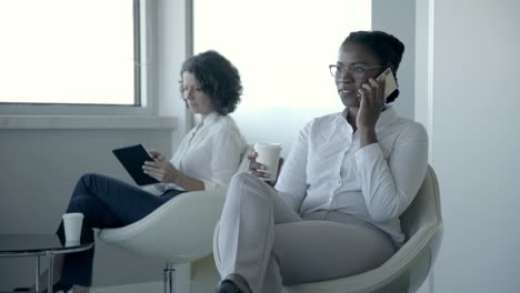 multiethnic businesswomen with digital devices