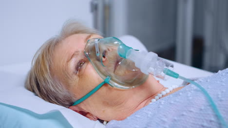 senior woman breathing slowly with oxygen mask