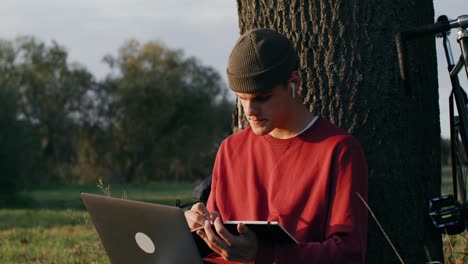 young man studying outdoors