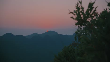 sunrise through limestone mountains at cat ba island of vietnam