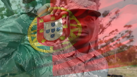 digital composition of waving portugal flag against soldier keeping an eye on the surroundings