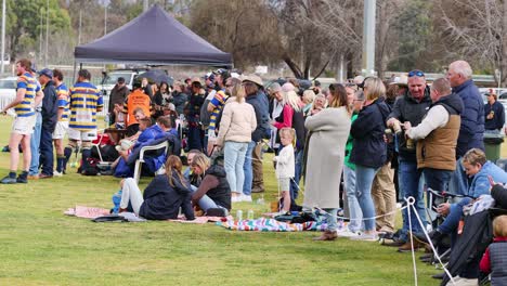 crowd watches and interacts at a local sports game