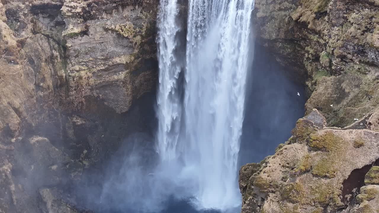 Skógafoss waterfall plunges into misty canyon near Eyjafjallajökull Iceland
