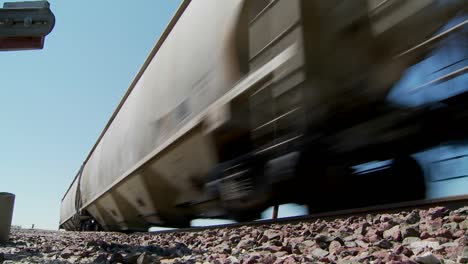 low angle of a train passing with roadbed in foreground 2