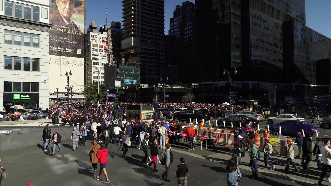 The crowd near Madison Square Garden is filled with Trump supporters, the sunlight highlighting their faces and signs