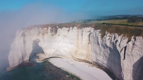 aerial view of the white cliffs of normandy with fog