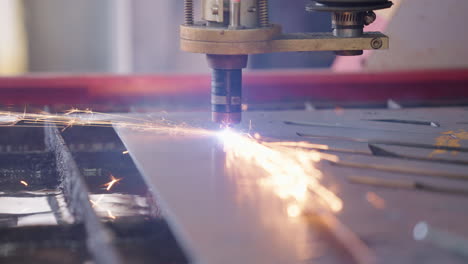 Close-Up-Nozzle-Of-Hot-Plasma-Cutting-Steel-Sheet-In-Industrial-Metal-Workshop,-4K