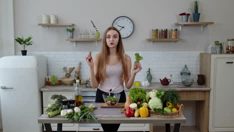 girl throwing pieces of lettuce on plate, telling the recipe. cooking salad with raw vegetables