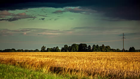 stormy, dark clouds gather and rain over a farmland field - dramatic cloudscape time lapse