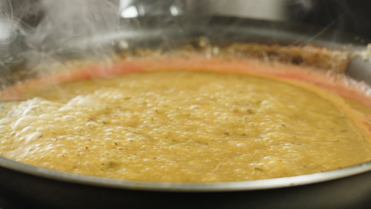 Cooking traditional Indian meal Palak Panir with spinach and cheese close up. Palak paneer is an Indian dish, consisting of paneer in a thick paste made from pureed spinach, Palak paneer is prepared by first boiling and pureeing spinach.