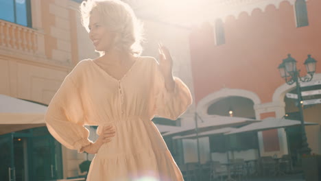 happy woman in a light beige dress outdoors