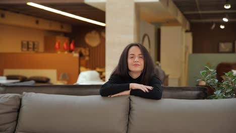 a cheerful woman poses over a stylish sofa showcasing modern interior design from a furniture store a cheerful woman poses over a stylish sofa showcasing modern interior design from a furniture store