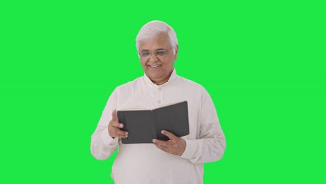 Happy-Indian-old-man-reading-a-book-Green-screen