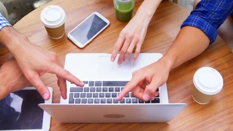 Colleagues-discussing-over-the-laptop-in-office-4K-4k