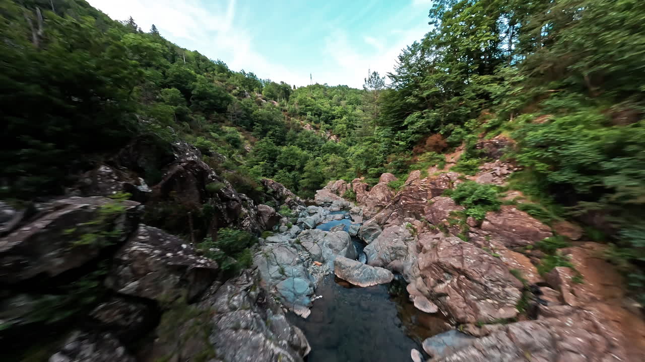 paisaje verde exuberante con terreno rocoso y una cascada serena en un cañón aislado