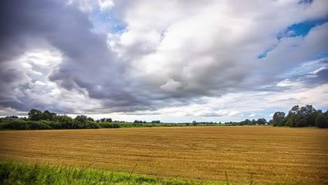 Timelapse-of-clouds-moving-over-rural-landscape-of-wheat-field