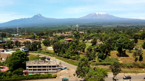 aerial drone view open air market in the loitokitok town, kenya and mount kilimanjaro- rural village of kenya