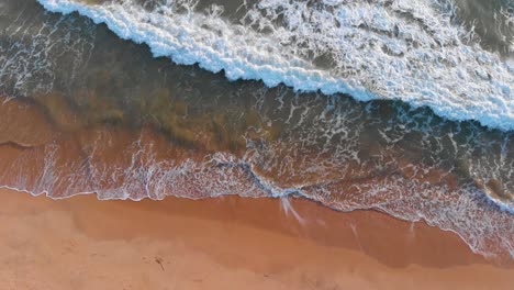 wave travelling to shore on a beach in algarve