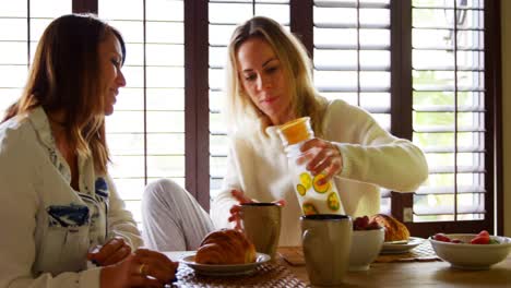 lesbian couple drink on dining table 4k