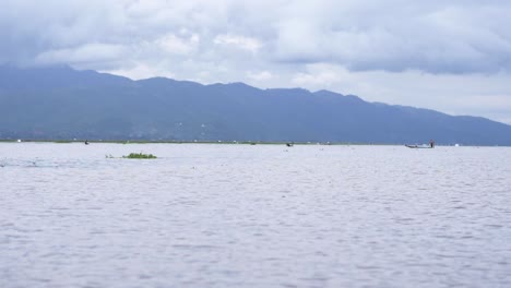 Boating-across-Inle-Lake,-Myanmar-in-cloudy-conditions