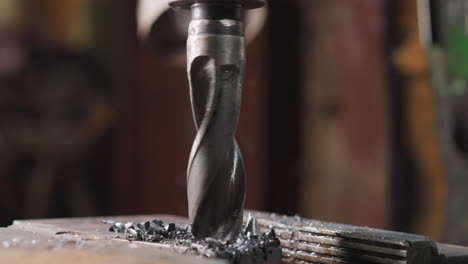 turning lathe machine bit goes down into metal workpiece