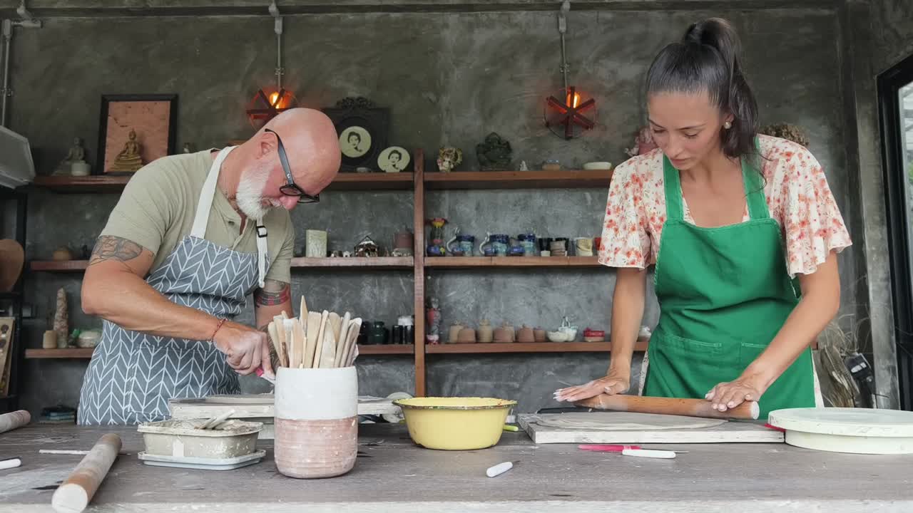Man and Woman Crafting Pottery in a Creative Workshop