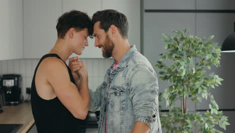 close affectionate gay couple in kitchen