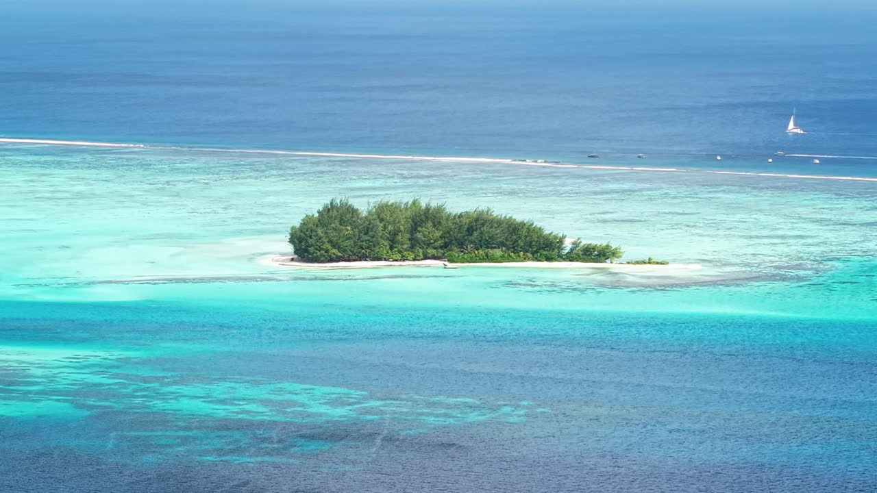 Aerial View of Small Island in Bora Bora Lagoon, French Polynesia. Coral Reef Barrier and Turquoise Ocean Water