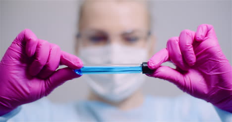 Working-In-Lab-Scientist-Holding-Test-Tubes-Positive-Test-Of-Covid-19-Coronavirus-At-Laboratory-2