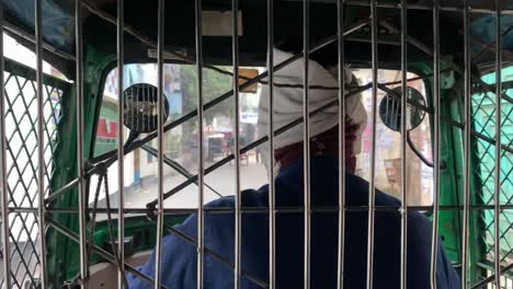 rickshaw driver guiding it through narrow streets on the city