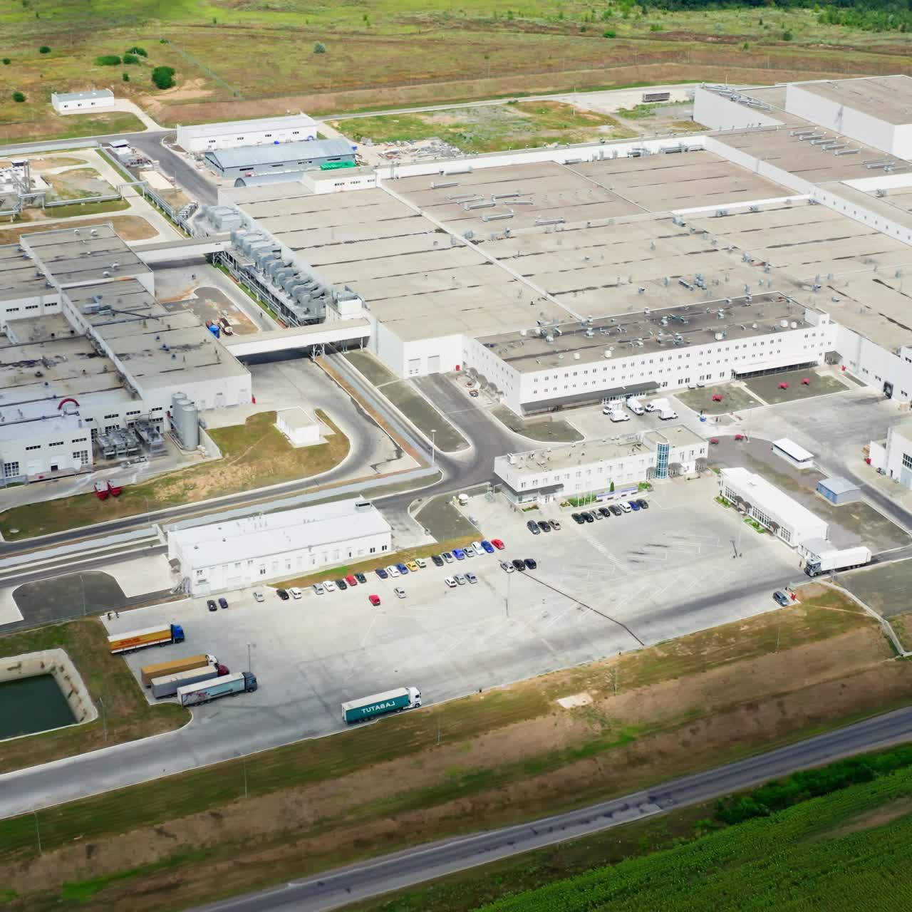 Large production plant. Harmful manufacturing area on field. Territory of industrial factory. Modern technology manufacturing plant. Aerial view
