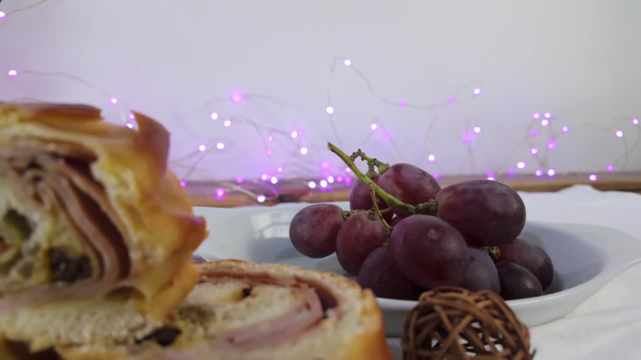 Fresh grapes with colorful lights in the background, festive mood with holiday food