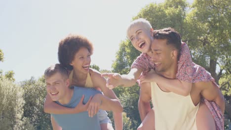 Portrait-of-happy-diverse-group-of-friends-playing-in-garden-in-summer