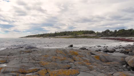 Beautiful-rocky-Jomfruland-Norwegian-coastline,-aerial-pull-away-reveal