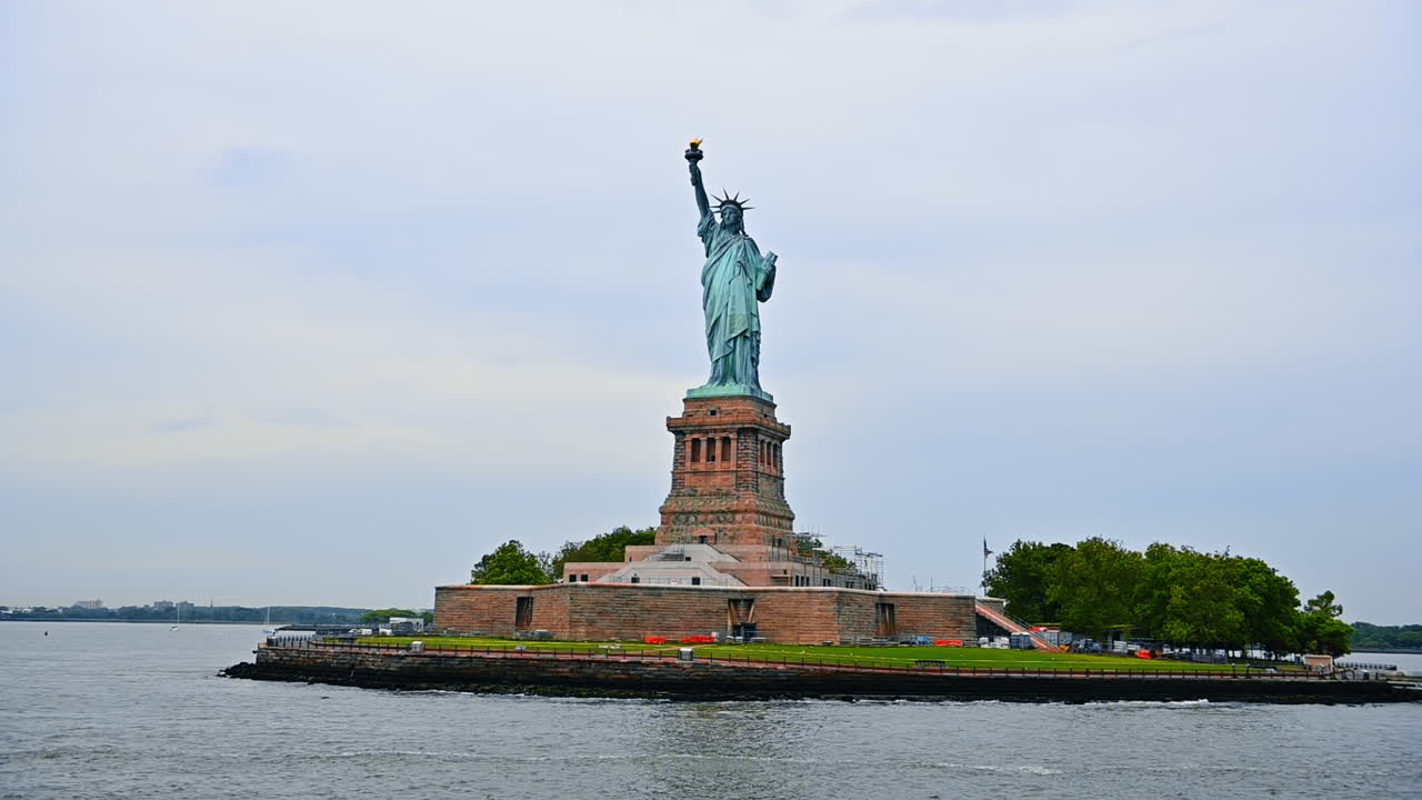 Travelling on board around the Liberty Island in Upper New York Bay. Low angle view on the iconic Statue of Liberty. New York, USA