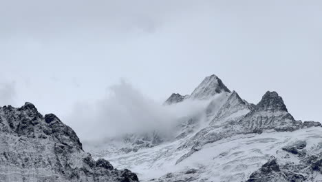 Grindelwald-mountain-glacier-glacial-peaks-Switzerland-Swiss-Alps-snowy-Jungfrau-Junfrangu-Lauterbrunnen-October-cloudy-autumn-evening-landscape-top-of-gondola-ride-view-zoomed-static-shot