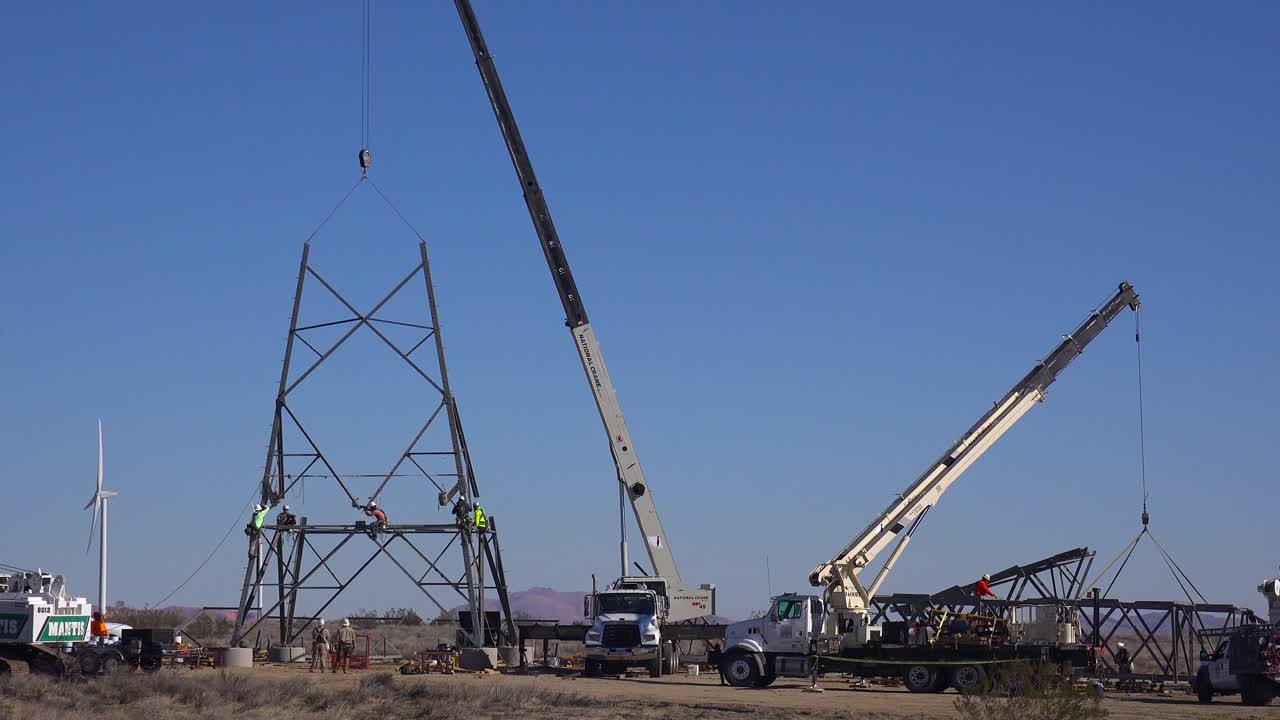 trabajadores estadounidenses ensamblan transformadores y cables eléctricos de alta tensión para construir infraestructura estadounidense