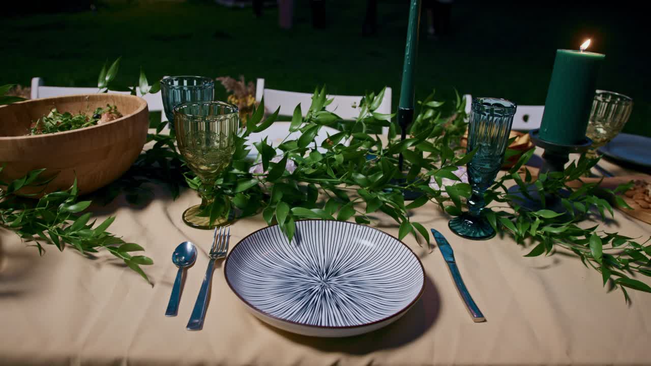 Elegant table setting with candles and greenery