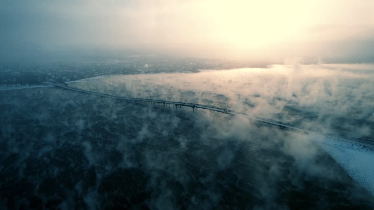 Steam Fog on Okanagan Lake and William R. Bennett Bridge in Kelowna BC, Canada