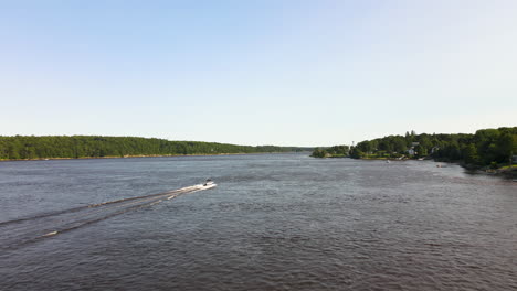 drone chasing after a speeding boat on a river