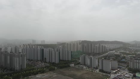 aerial view of a cityscape shrouded in haze