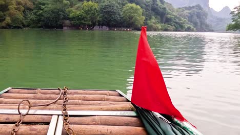 wooden raft with red flag on tranquil water